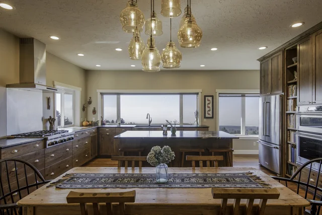 Finished kitchen with custom warm wood cabinetry and island