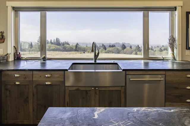 Wood cabinetry and drawers fitted around a sink work zone
