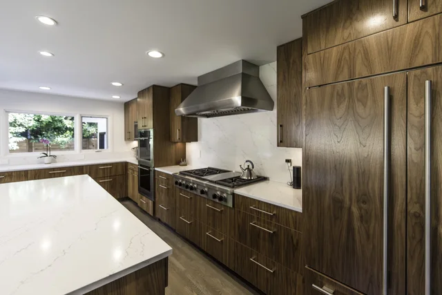 Fitted wood cabinetry installed across a finished kitchen