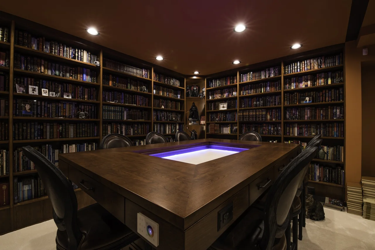 Finished library shelves surrounding a central wood table