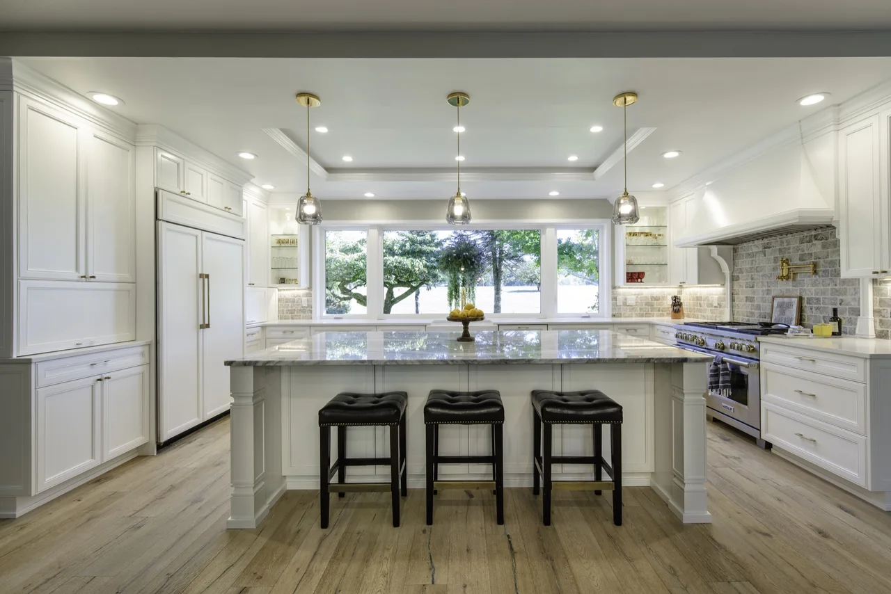 Bright white fitted kitchen cabinetry with a large island