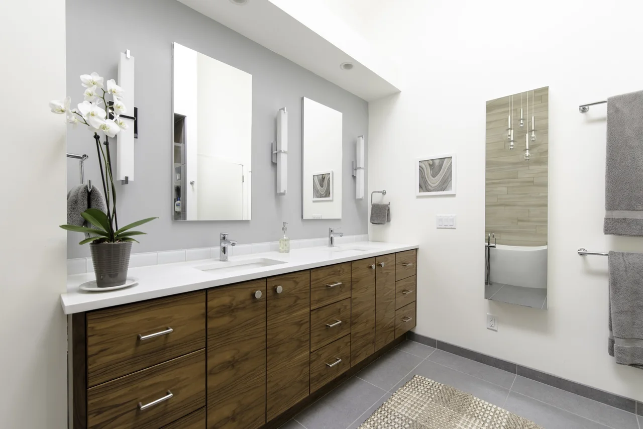 Long double vanity with warm wood drawer and door storage