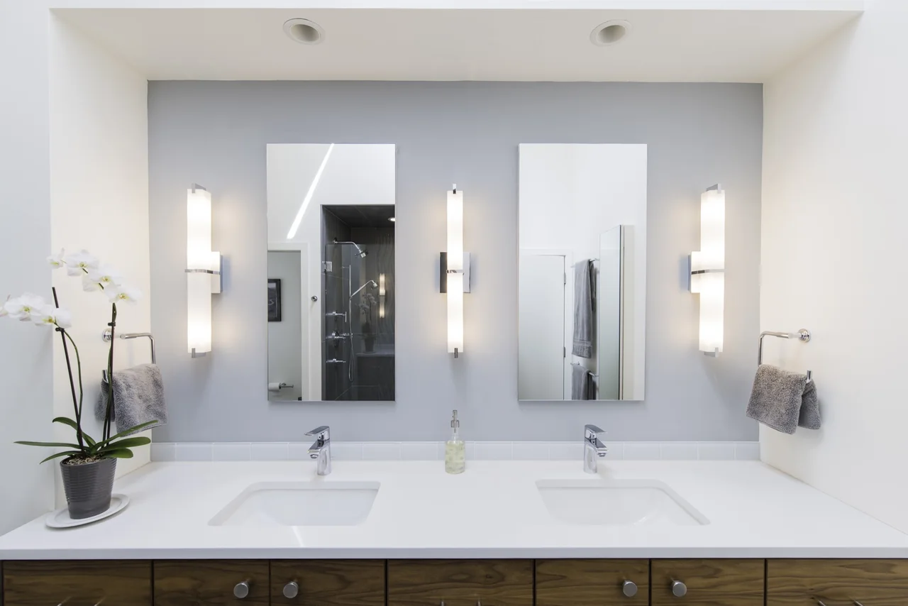 Centered view of a double vanity beneath three mirrors