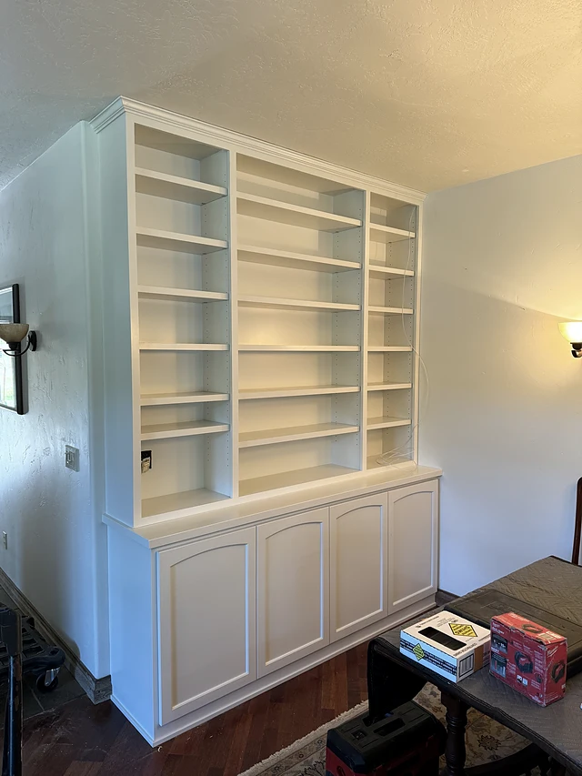 White full-height built-in shelves over lower cabinetry