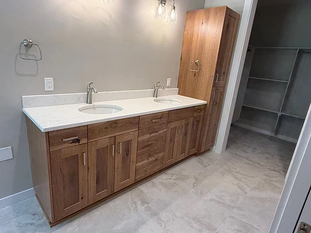 Wood double vanity with adjacent tall storage