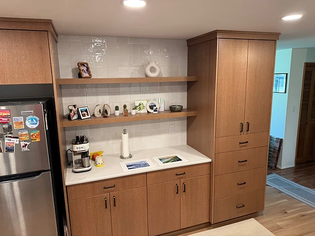 Warm wood kitchen built-in with open shelves and tall storage